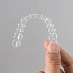 Patient holding clear aligner