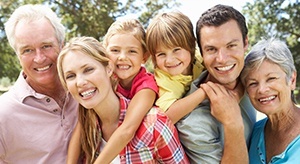 Family of six smiling at at a park