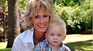 Grandmother holding grandson smiling