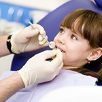 Young girl receiving dental treatment