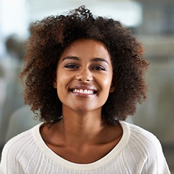 Woman smiling with dental crown in Grapevine