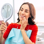 Woman admiring smile after getting dental bonding