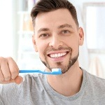 man brushing his teeth