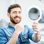 man admiring his smile in the mirror