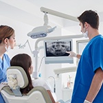 dentist showing a patient her dental X-rays