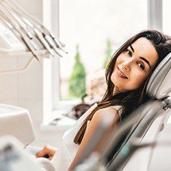 Smiling woman in dental chair for Invisalign consultation
