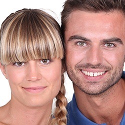 Smiling man and woman in need of Invisalign treatment