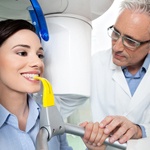 Doctor positioning female patient before cone beam scan