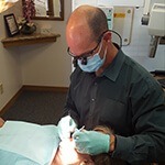 Dr. Greg Martin examining patient's teeth