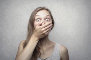 Woman in shock covering her mouth